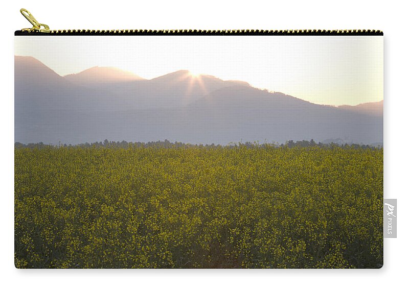 Brnik Zip Pouch featuring the photograph Sunrise bursting over the kamnik alps and rapeseed by Ian Middleton