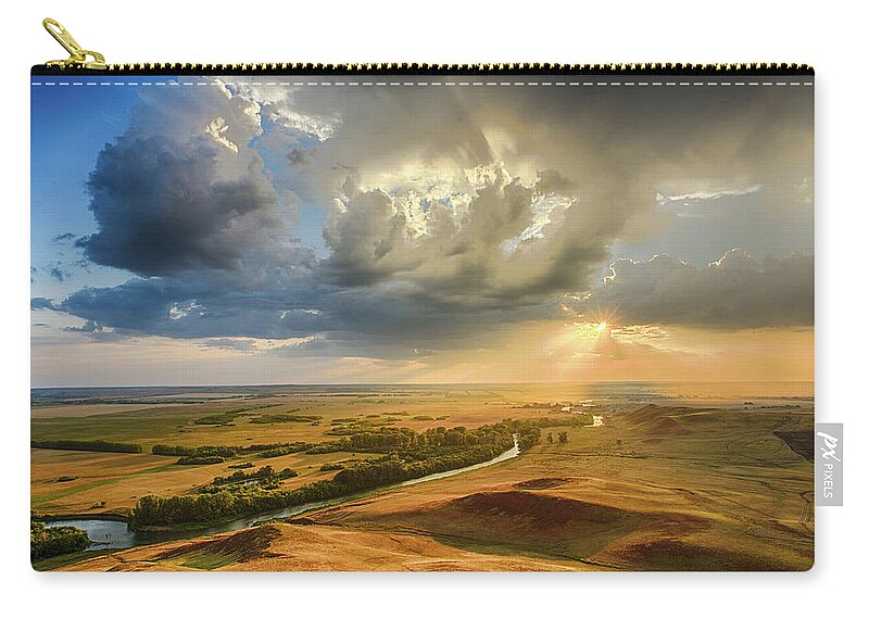 Hilltop Zip Pouch featuring the photograph Sunset Through the Rain Clouds by John Williams