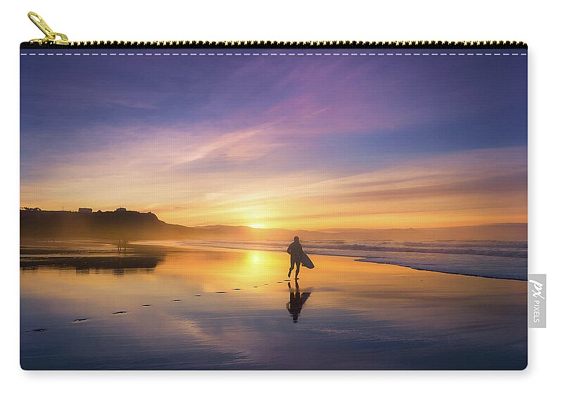 Surfer Zip Pouch featuring the photograph Surfer In Beach At Sunset by Mikel Martinez de Osaba