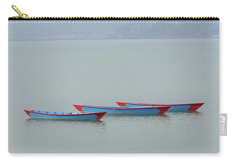 Boat Zip Pouch featuring the photograph Three blue boats on Phewa Lake in Pokhara by Dutourdumonde Photography