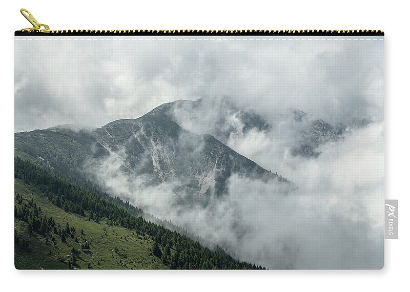 Summit Zip Pouch featuring the photograph Top of a Mountain covered with fog by Nicola Aristolao