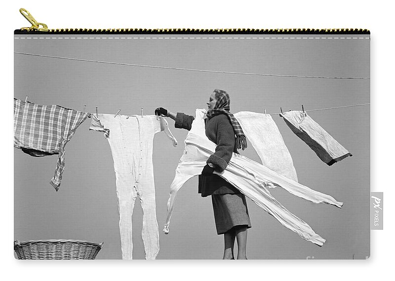 1940s Zip Pouch featuring the photograph Woman Removing Frozen Clothes by Debrocke/ClassicStock