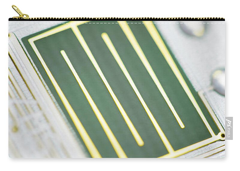 Tin Carry-all Pouch featuring the photograph Close-up Of A Circuit Board by Nicholas Rigg