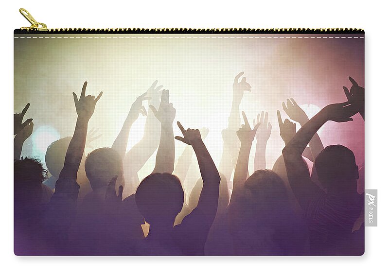 Young Men Zip Pouch featuring the photograph Crowd Of People At Concert Waving Arms #1 by Flashpop