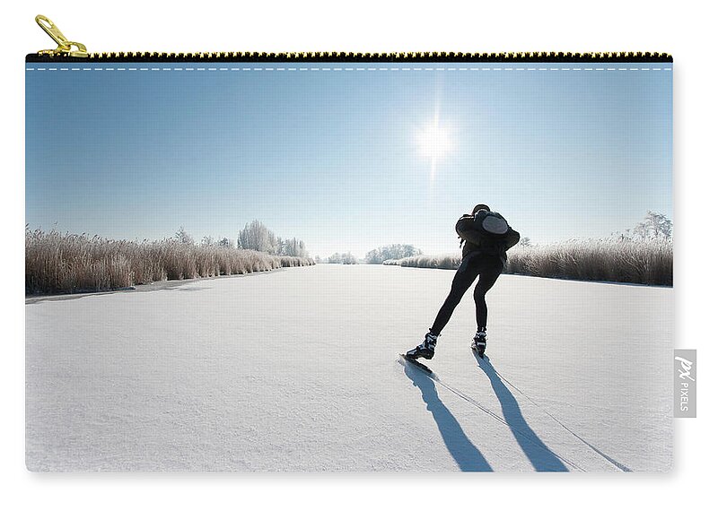 Scenics Zip Pouch featuring the photograph Ice Skating #1 by Jaap-willem