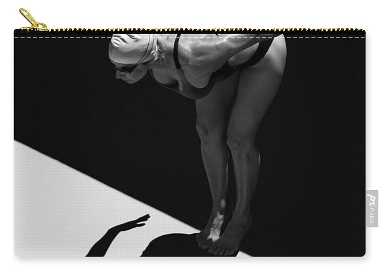 Shadow Zip Pouch featuring the photograph A Woman Prepares To Jump Backwards Off #2 by Ben Welsh