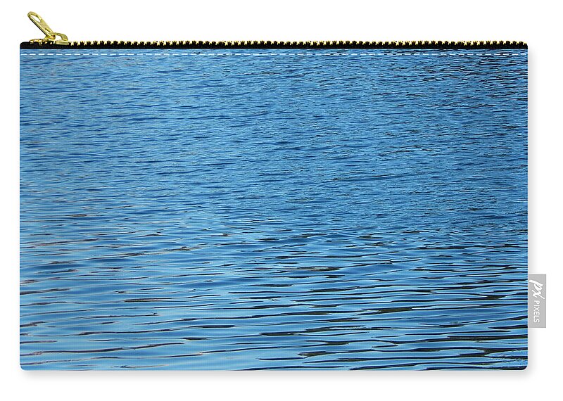 Water Zip Pouch featuring the photograph Texture of water ripples on the surface of the river #5 by Oleg Prokopenko