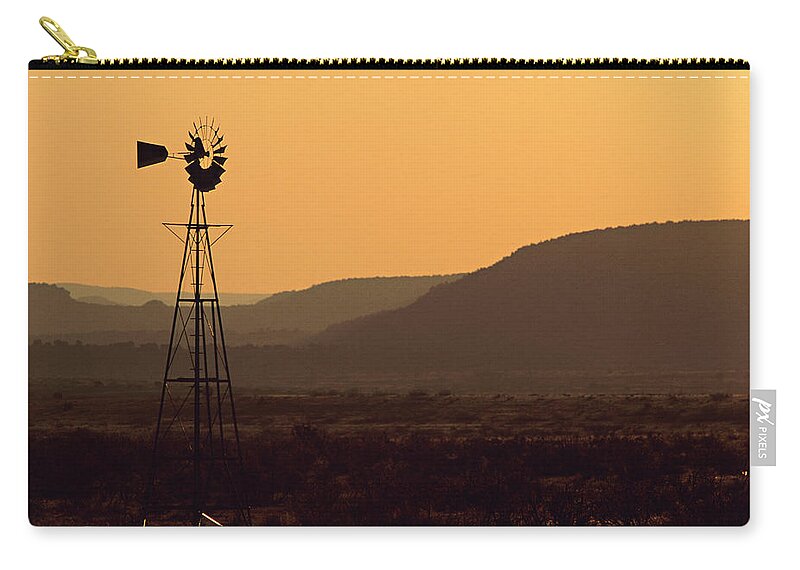 Tranquility Zip Pouch featuring the photograph A Desert Windmill At Sunset by Wesley Hitt