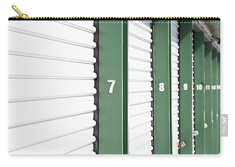 Shadow Zip Pouch featuring the photograph A Row Of Locked Storage Units At A Self by Frederick Bass