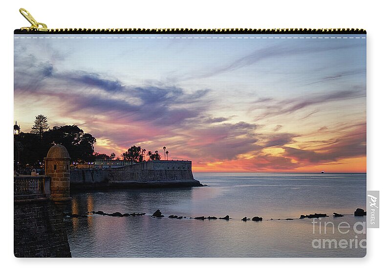 Illumination Zip Pouch featuring the photograph Amazing and Colorful Cloudy Sky at Dusk over Candelaria Bulwark Cadiz by Pablo Avanzini