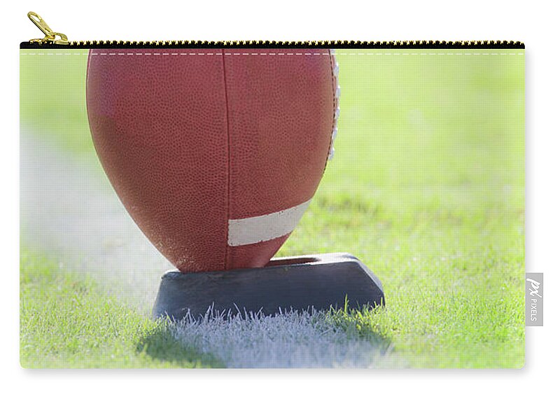Grass Zip Pouch featuring the photograph American Football On Kicking Tee by David Madison
