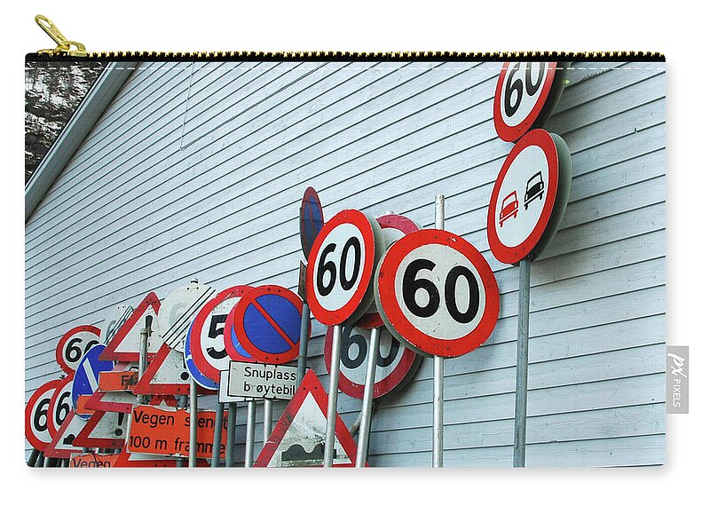 Large Group Of Objects Zip Pouch featuring the photograph Assorted Road Signs Stacked Against by Kjerstin Gjengedal
