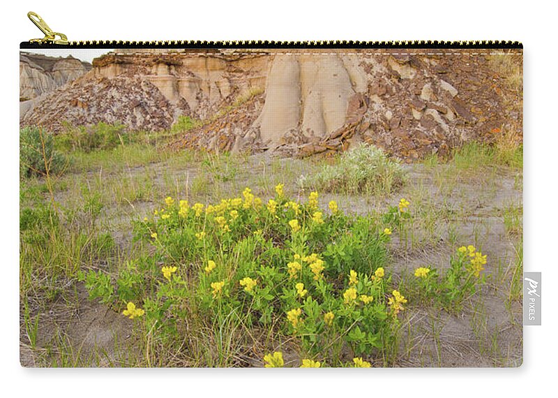 Tranquility Zip Pouch featuring the photograph Badlands Hoodoos And Wildflowers by Rebecca Schortinghuis