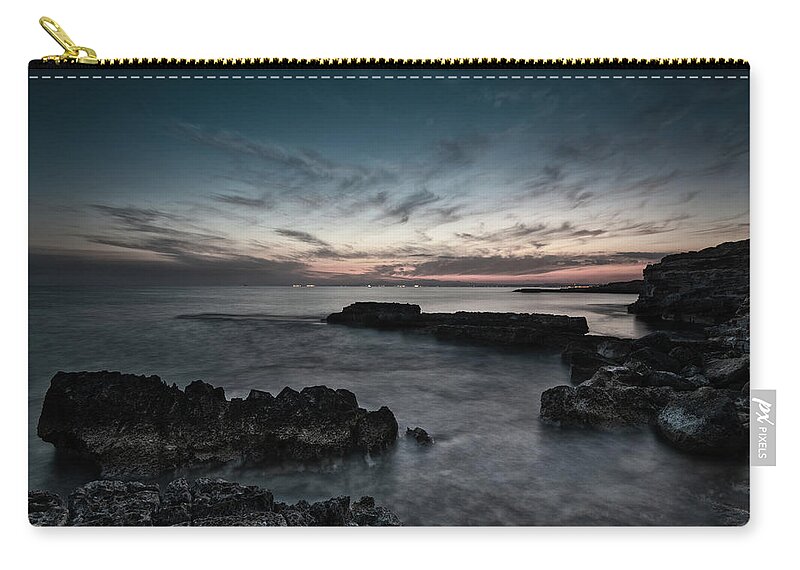 Seascape Zip Pouch featuring the photograph Beautiful dramatic Sunset on a rocky coastline by Michalakis Ppalis