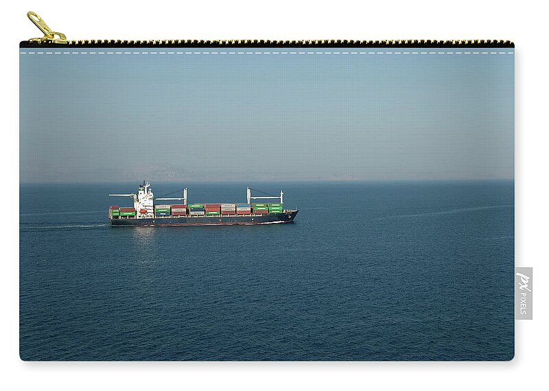 Freight Transportation Zip Pouch featuring the photograph Cargo Ship At Sea by Mitch Diamond