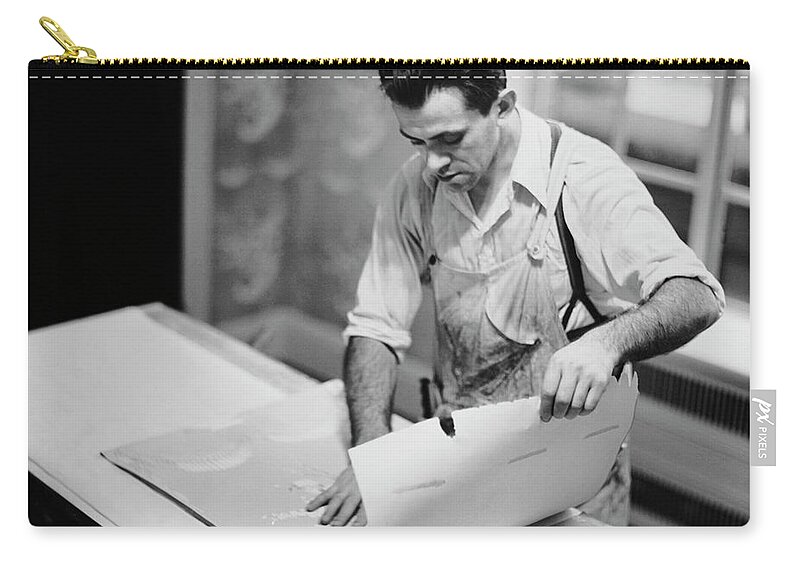 House Painter Zip Pouch featuring the photograph Carpenter Putting On Wallpaper by George Marks