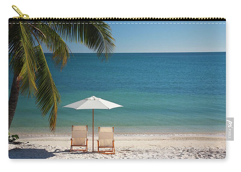 Tropical Tree Zip Pouch featuring the photograph Chair On Florida Keys Beach by Cdwheatley