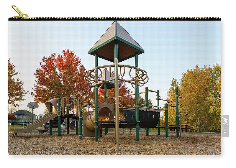 Children Zip Pouch featuring the photograph Children Playground in Neighborhood Park in Fall Season by David Gn