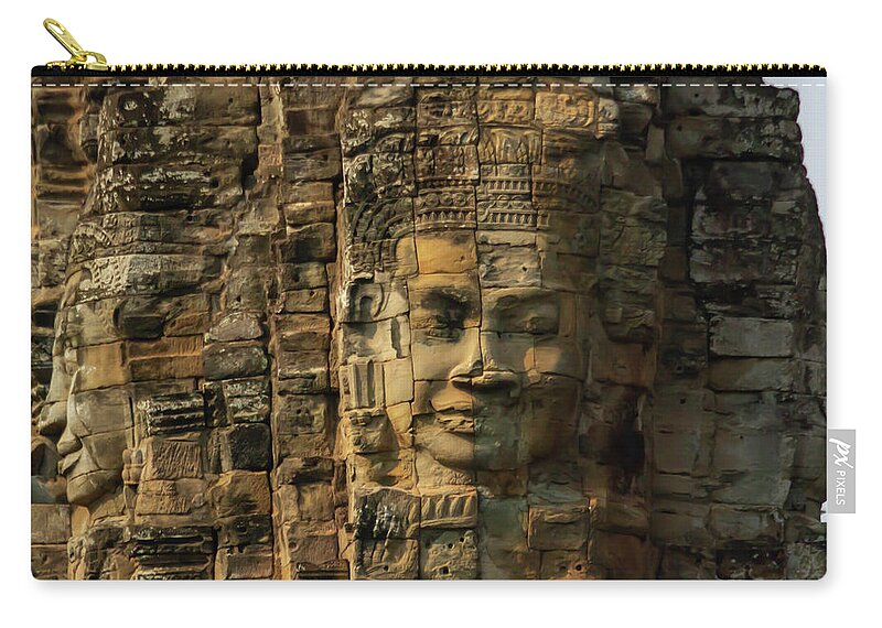 Ancient Zip Pouch featuring the photograph Close up of faces on towers at Bayon Temple in Angkor Tom, Siem by Karen Foley