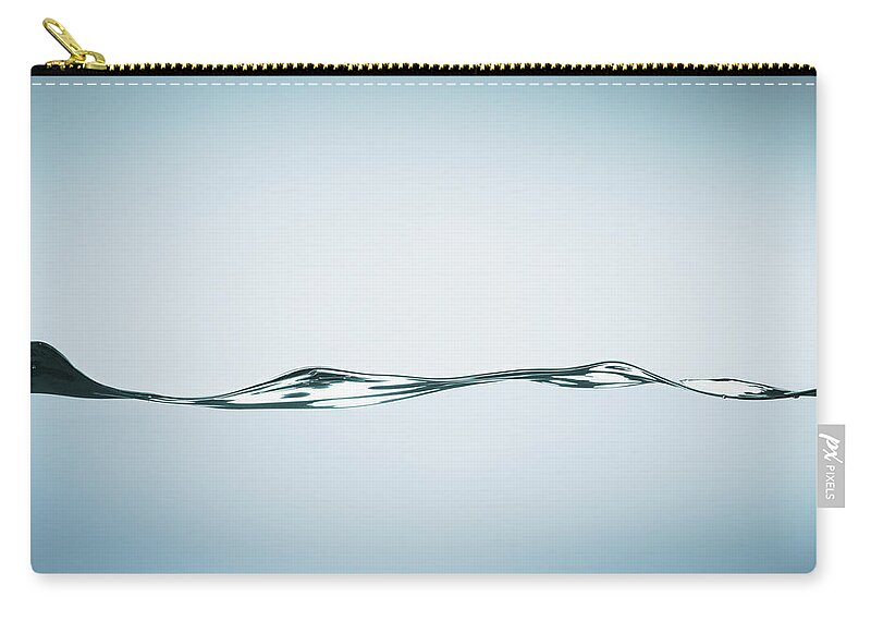 Motion Zip Pouch featuring the photograph Close Up Of Rippling Water by Martin Barraud