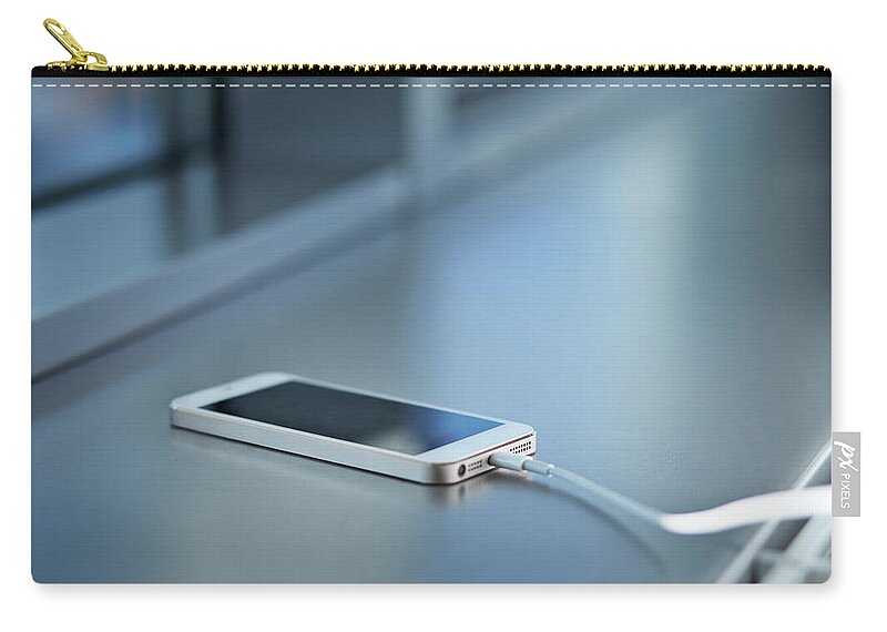 Office Zip Pouch featuring the photograph Close-up Of Smartphone Charging by Klaus Vedfelt