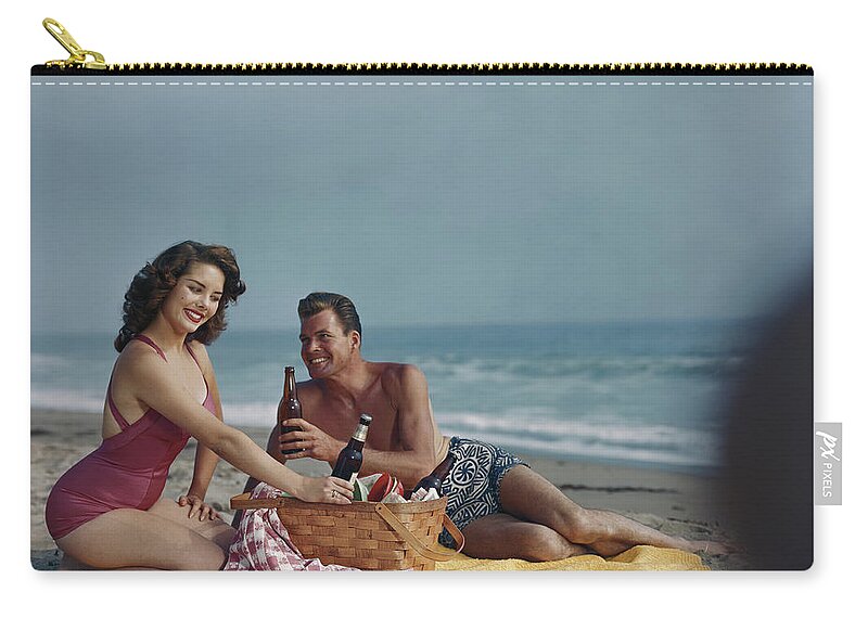 Heterosexual Couple Zip Pouch featuring the photograph Couple Sitting On Beach Holding Beer by Tom Kelley Archive