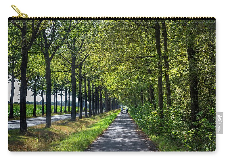 Spring Zip Pouch featuring the photograph Cycling in Holland by Debra and Dave Vanderlaan