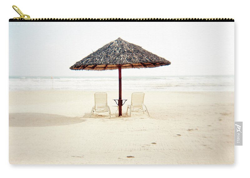 Scenics Zip Pouch featuring the photograph Deckchairs With Bamboo Thatch Umbrella by Xpacifica
