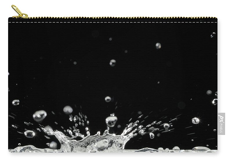 Black Background Zip Pouch featuring the photograph Drop Of Water Splashing, Close Up by Sami Sarkis