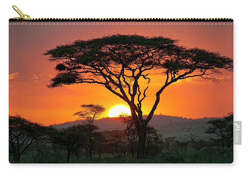 Scenics Zip Pouch featuring the photograph End Of A Safari-day In The Serengeti by Guenterguni