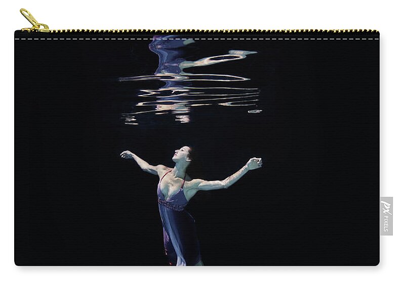 Ballet Dancer Zip Pouch featuring the photograph Female Dancer Underwater Against Black by Thomas Barwick