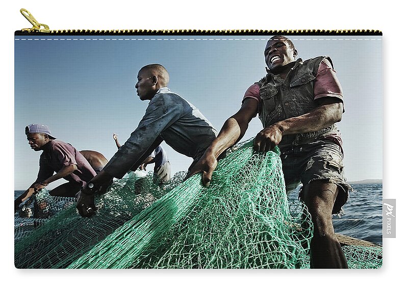 Young Men Zip Pouch featuring the photograph Fishermen Pulling In Net In Water by Cultura Rm Exclusive/led
