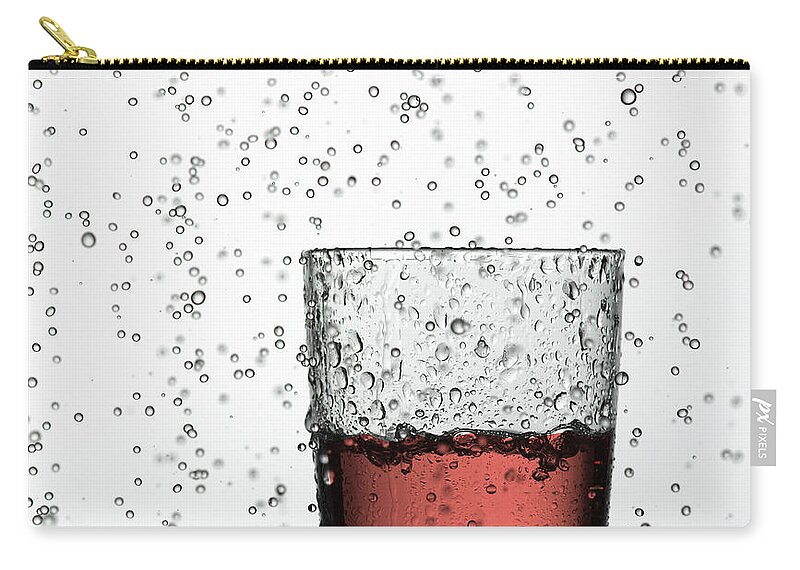 White Background Zip Pouch featuring the photograph Glass Of Juice In Water Drops by Walter Zerla