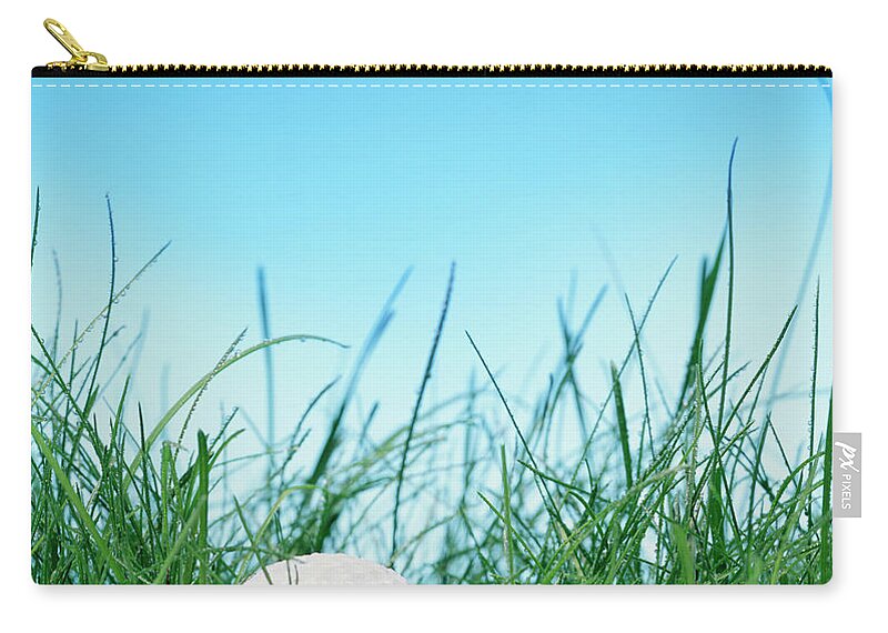 Grass Zip Pouch featuring the photograph Golf Ball In Long Grass by Peter Dazeley
