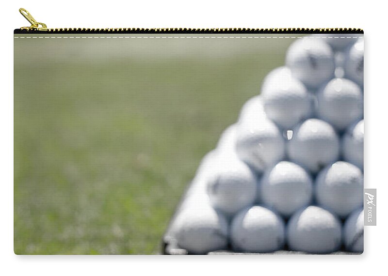 Grass Zip Pouch featuring the photograph Golf Balls Arranged In Pyramid On Course by Joe Mcbride
