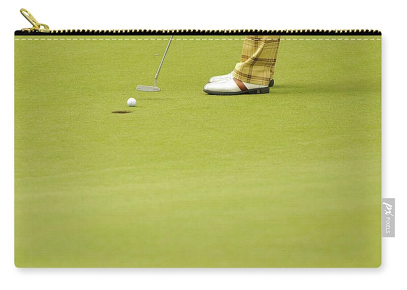 Grass Zip Pouch featuring the photograph Golfer Putts A Golf Ball Into A Hole by Photo © Stephen Chung