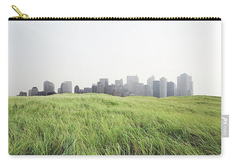 Grass Zip Pouch featuring the photograph Grass And Cityscape by Richard Newstead