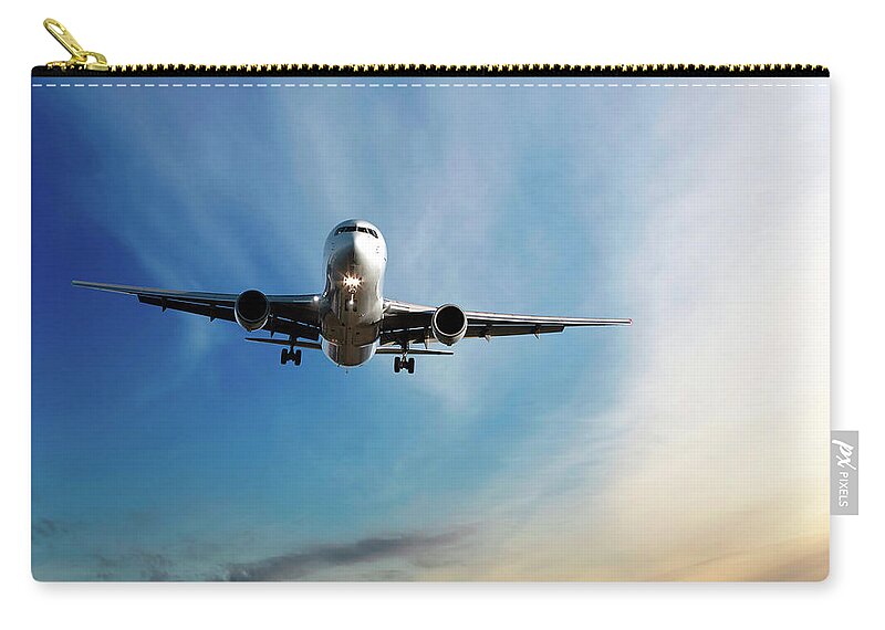 Dawn Zip Pouch featuring the photograph Jet Airplane Landing At Dusk by Sharply done