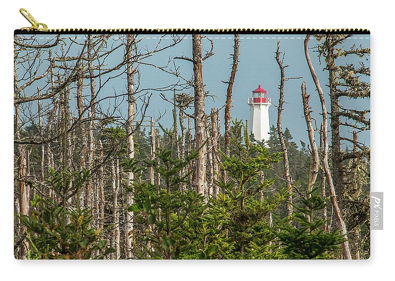 Lighthouse Zip Pouch featuring the photograph Lighthouse Between the Trees by Ginger Stein