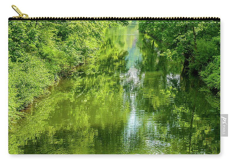 River Zip Pouch featuring the photograph Lush green paradise tranquil Creek Scene with Green Lush Trees, shrubs and Bushes at the Riverbank by Ulrich Wende