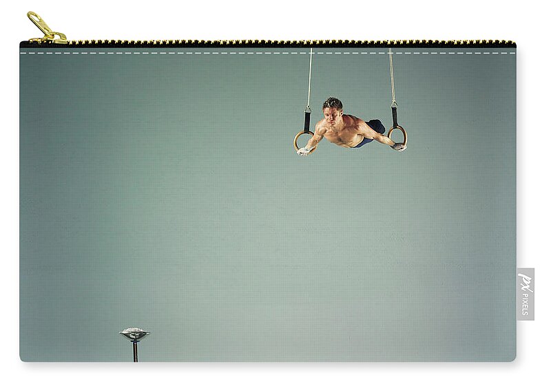 Hanging Zip Pouch featuring the photograph Male Athlete Practising A Rings Exercise by 10'000 Hours