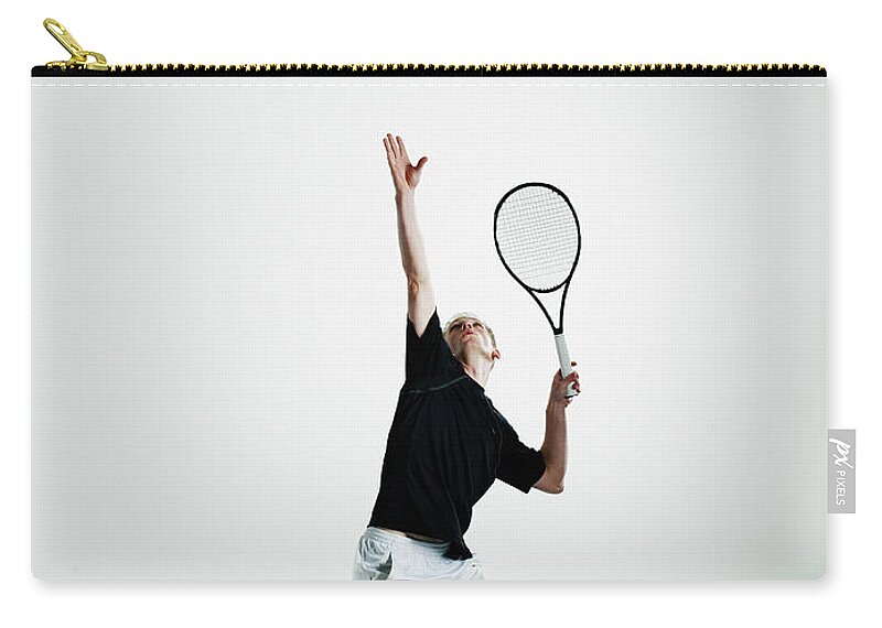 Tennis Zip Pouch featuring the photograph Male Tennis Player Serving Ball by Thomas Barwick