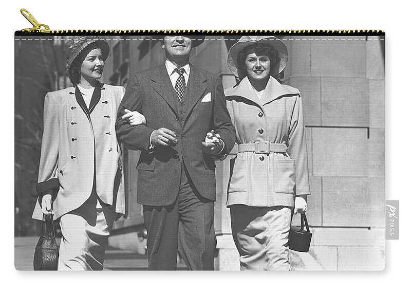 Fedora Zip Pouch featuring the photograph Man And Two Women Walking On Sidewalk by George Marks