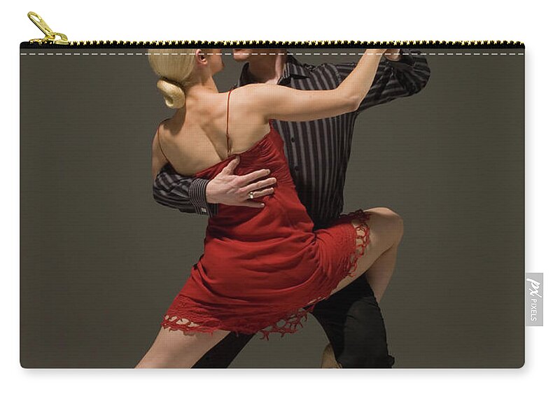 Coordination Zip Pouch featuring the photograph Man And Woman Dancing Tango by Pm Images