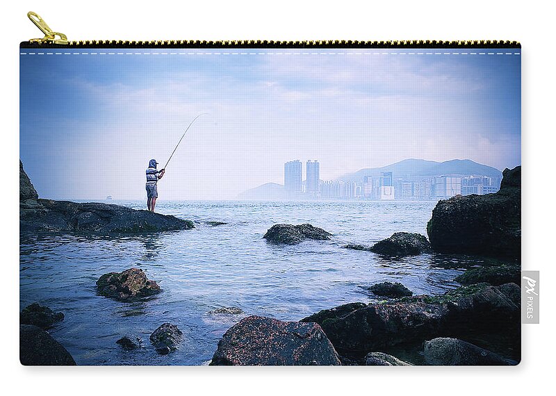 Hooded Shirt Zip Pouch featuring the photograph Man Fishing In Victoria Harbour by Nick Kee Son