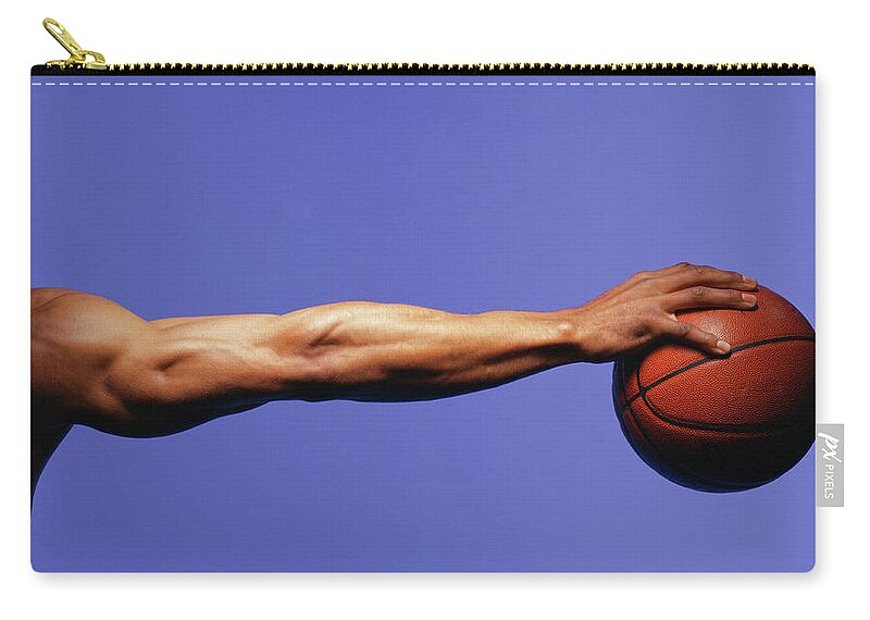 Human Arm Zip Pouch featuring the photograph Man Palming Basketball, Close-up Of Arm by Blaise Hayward