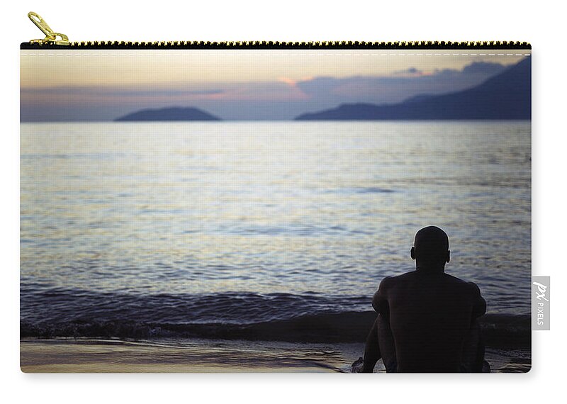 Young Men Zip Pouch featuring the photograph Man Sitting Alone On A Beach by Win-initiative/neleman