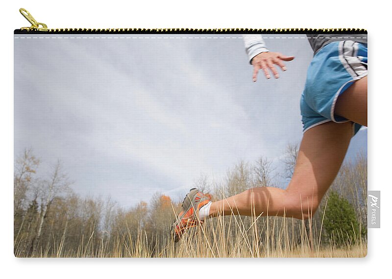 Grass Family Zip Pouch featuring the photograph Mature Woman Running Through Tall by Caroline Woodham