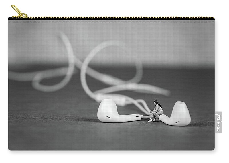 Concept Zip Pouch featuring the photograph Miniature Figure listening to Music and Sitting on Earbuds by Tammy Ray