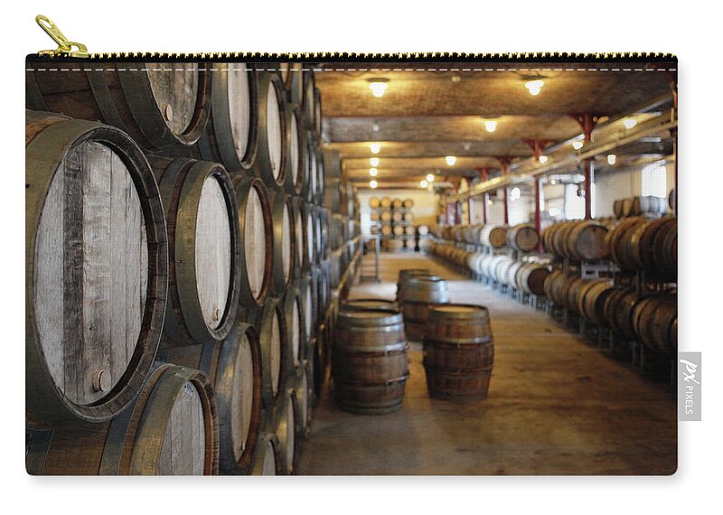 Alcohol Zip Pouch featuring the photograph Oak Barrels In A Winery by Marc Volk